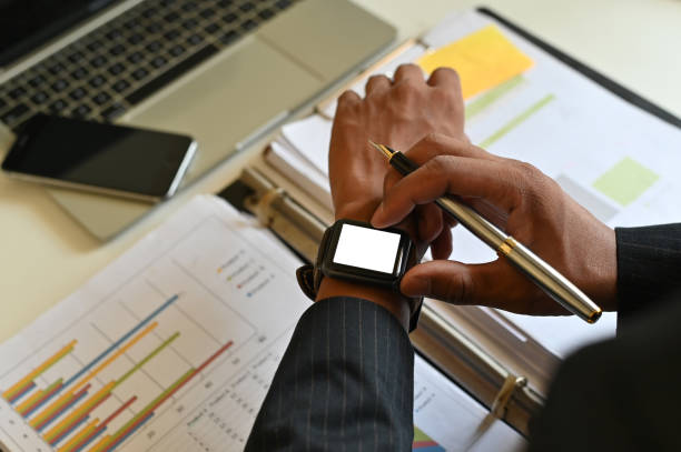 Cropped shot top view business using mockup smartwatch. Cropped shot top view business using mockup smartwatch. smart watch business stock pictures, royalty-free photos & images
