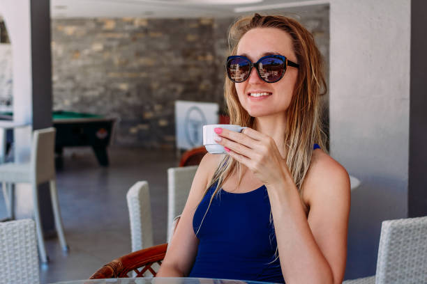 istock a young woman with a cup of coffee 1154004519