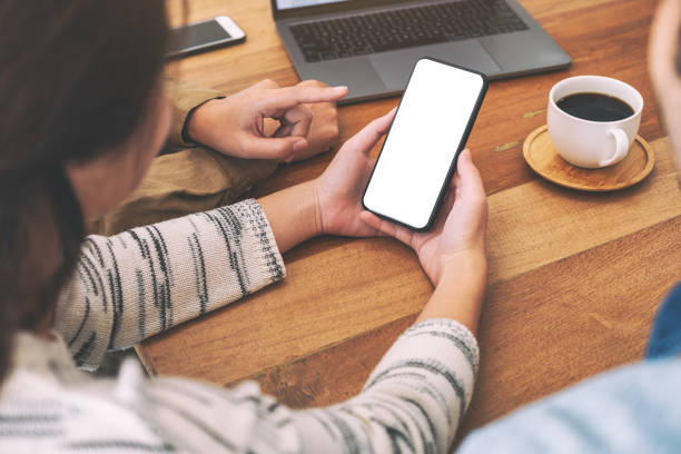 istock People using and looking at the same mockup mobile phone on wooden table together 1154009830