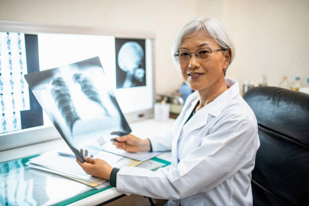 istock Senior Female Japanese Physician Studying X-Ray Imagery 1154010401