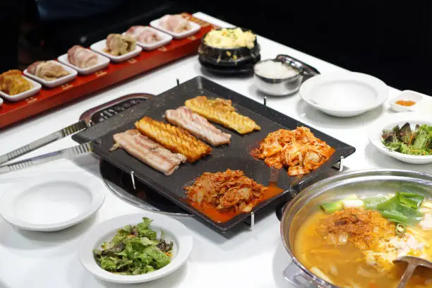 Photo of Korean grilled pork belly BBQ (Samgyeopsal Gui) - The popular Korean barbecue dish, served with fresh lettuce and a spicy dipping sauce.