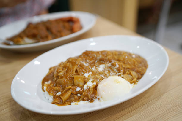 istock Japanese curry rice with thinly sliced boiled pork and soft boiled egg. 1154013077