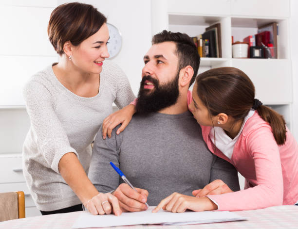 istock Parents signing property papers 1154015952