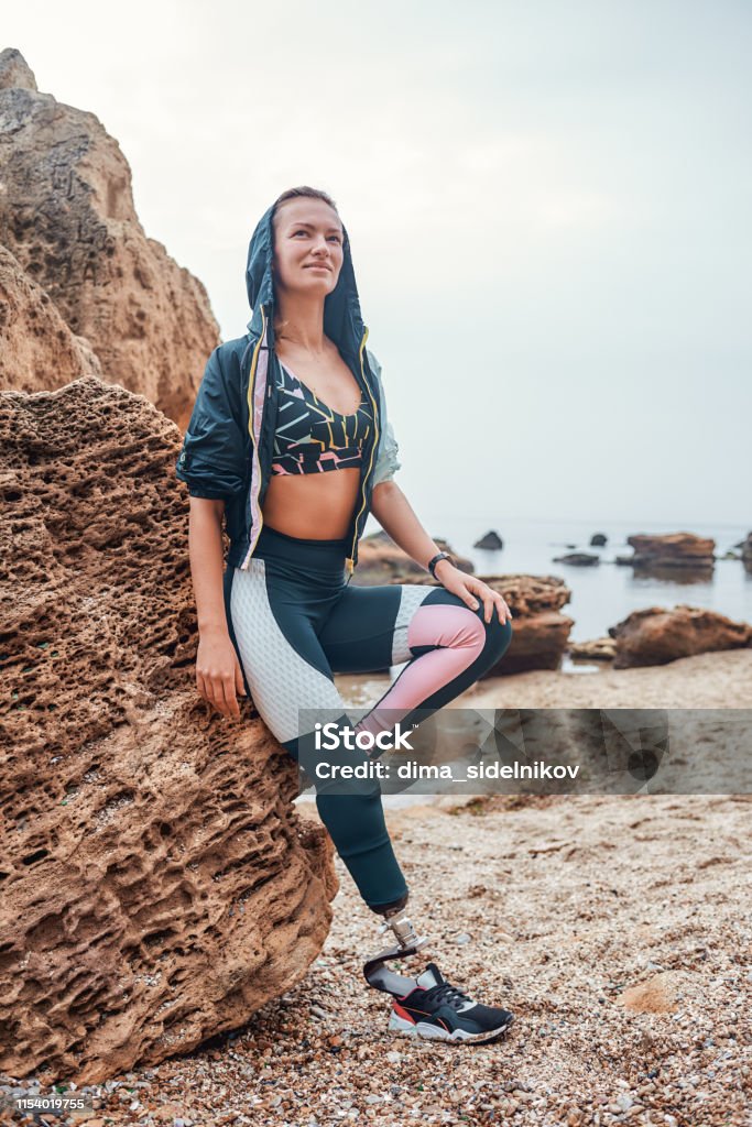Challenging My Body Full Length Of Young Positive Disabled Woman With Prosthetic  Leg In Sports Clothing Standing On The Beach After Morning Workout Stock  Photo - Download Image Now - iStock