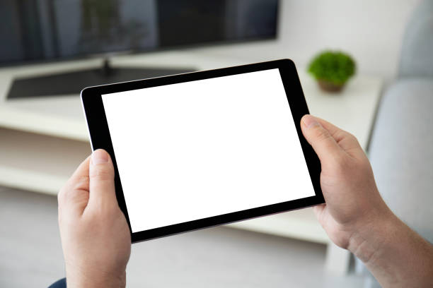 istock man hands holding computer tablet with isolated screen in room 1154019945