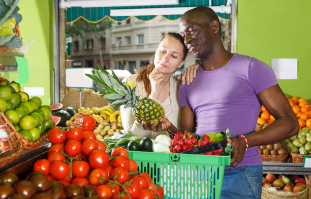 istock Young couple is standing with basket 1154022328