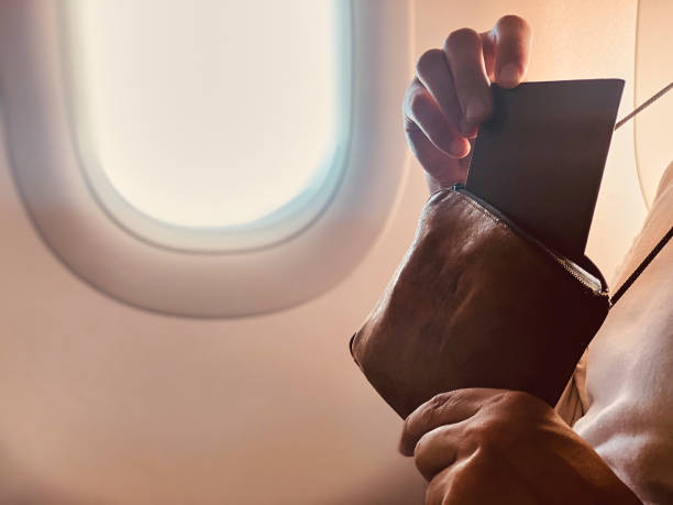 istock Airplane passenger with a neck bag for safe carrying money and documents. 1154023558