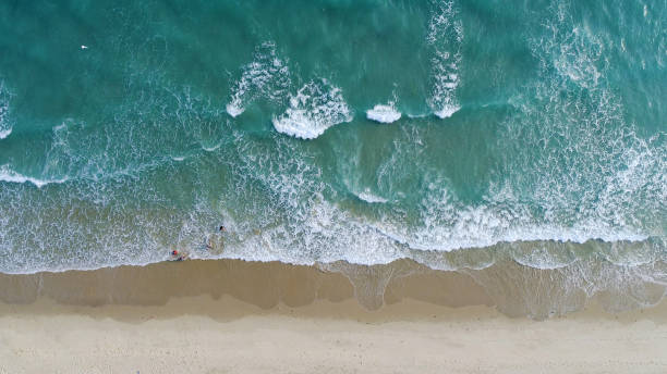 istock Beach on aerial drone top view with ocean waves reaching shore. 1154023563