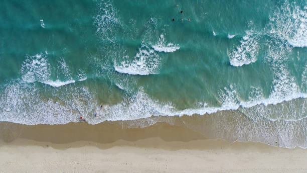 istock Beach on aerial drone top view with ocean waves reaching shore. 1154023566