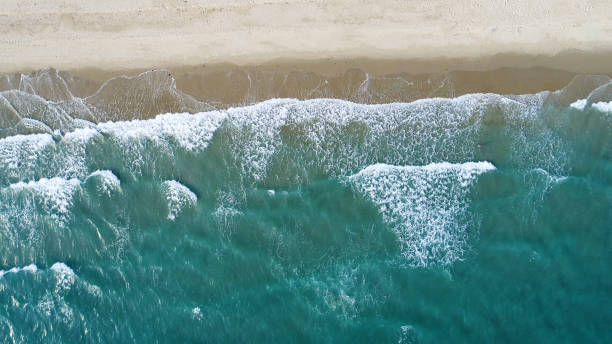istock Beach on aerial drone top view with ocean waves reaching shore. 1154023567