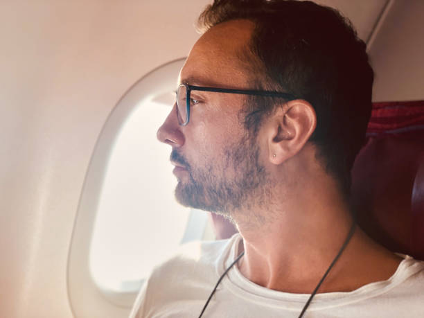 istock Airplane passenger with a neck bag for safe carrying money and documents. 1154023577