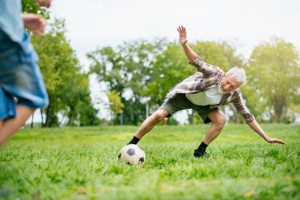 istock Grandfather and grandson enjoy a game 1154023647