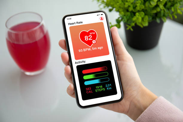 istock female hand holding touch phone with app heart and activity 1154023670
