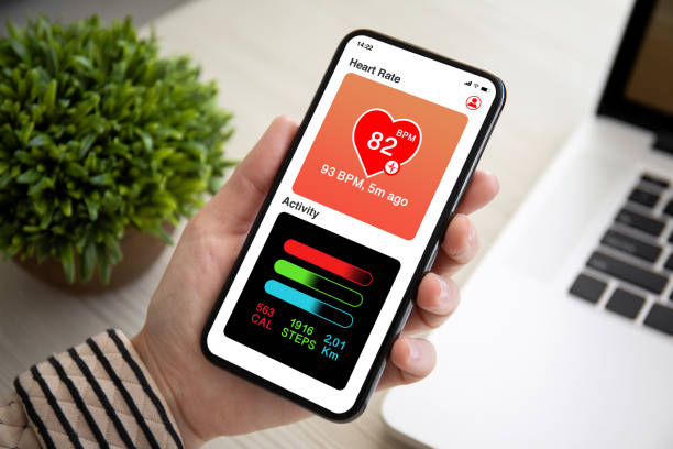 istock female hand holding touch phone with app heart and activity 1154023740