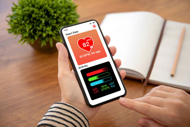 istock female hands holding phone with app heart and activity 1154023789