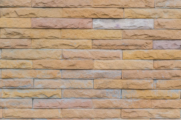istock yellow stone wall  made with stone blocks 1154023887