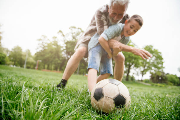 istock Grandfather and grandson enjoy a game 1154023937