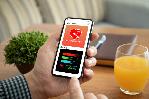 istock male hands holding phone with app heart and activity 1154024116