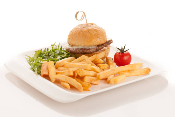 istock Gamburger with frenchfries on a plate isolated over white background 1154027366