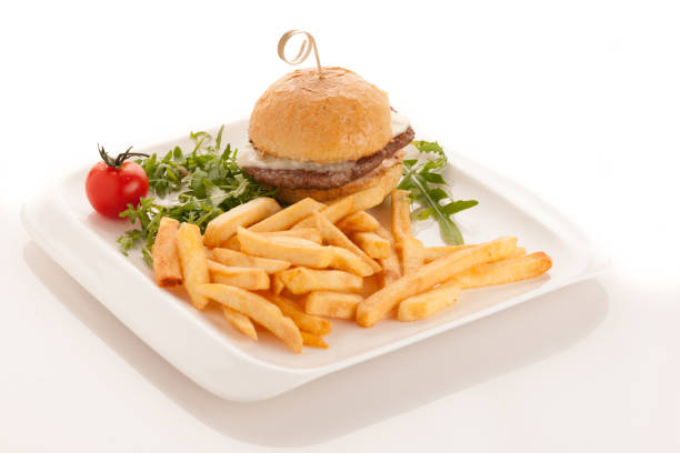 istock Gamburger with frenchfries on a plate isolated over white background 1154027382