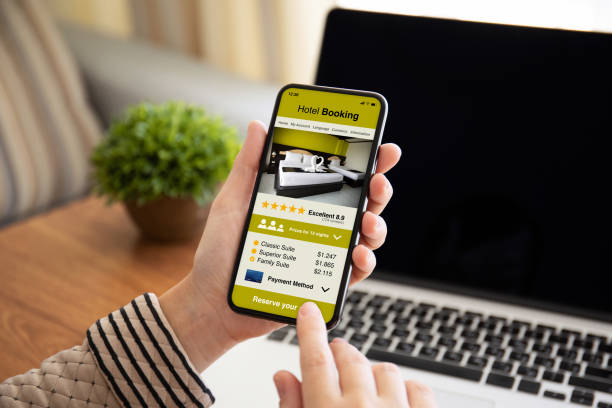 istock female hand holding phone with app hotel booking on screen 1154028481
