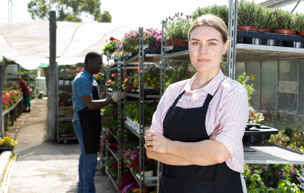 istock Florist girl working in greenhouse 1154032004