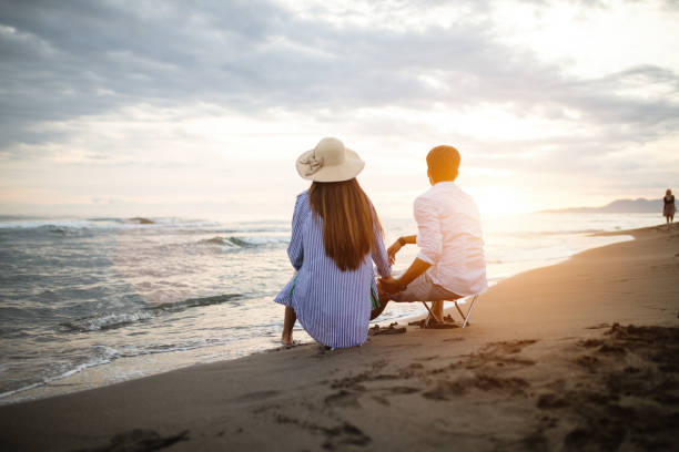 istock Happy young couple having fun and love on the beach 1154032079