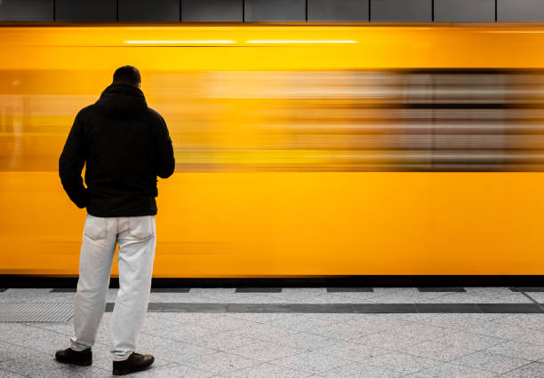 istock Rear View Of Person Standing By Moving Train 1154032163