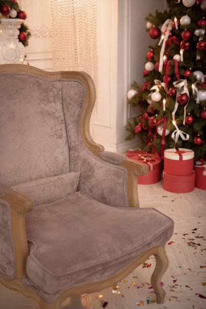 istock Christmas Tree and Christmas gift boxes in the interior with a fireplace. 1154032454