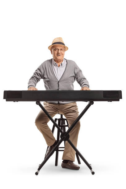 Senior man sitting and playing a keyboard