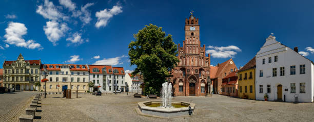 Listed architectural ensemble: "Altstädter Markt" in "Brandenburg an der Havel" with old town hall and "Roland" (a medieval statue that symbols the municipal law) stock photo
