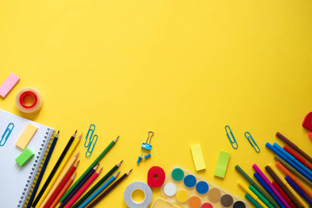istock Back to school. Items for the school on a yellow table. 1154035500
