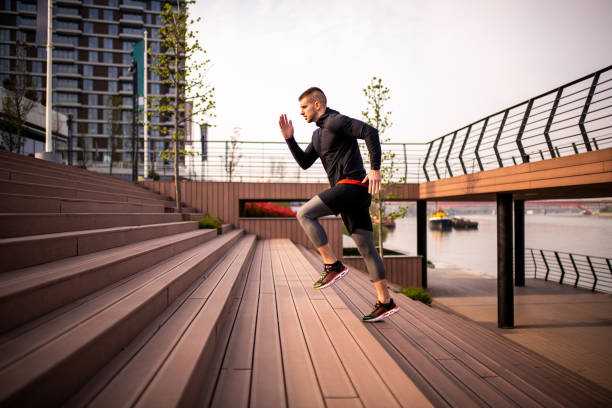istock Side view on a sporty man running upstairs 1154035693