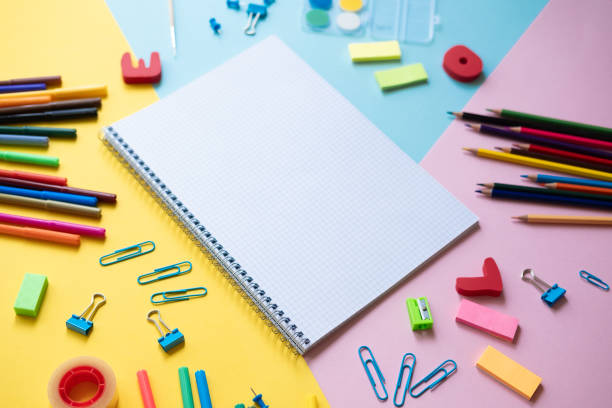 istock Notebook with school supplies on color background with copy space 1154035774
