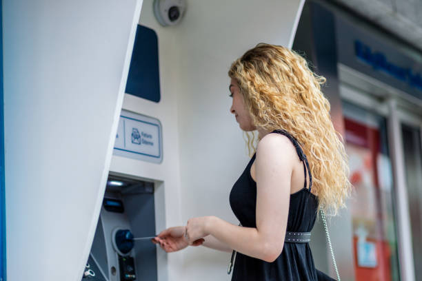 istock University student taking money from the ATM 1154036897