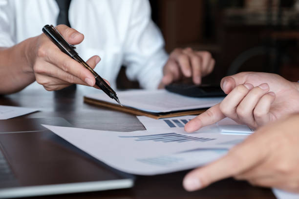 istock Economic research discussions, Business team analyzing income charts and graphs to plan marketing concept with using calculator  for analysis. 1154037010