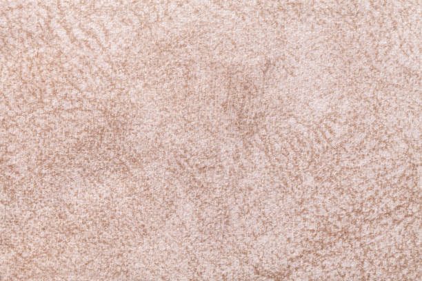 istock Light beige fluffy background of soft, fleecy cloth. Texture of textile closeup. 1154037238