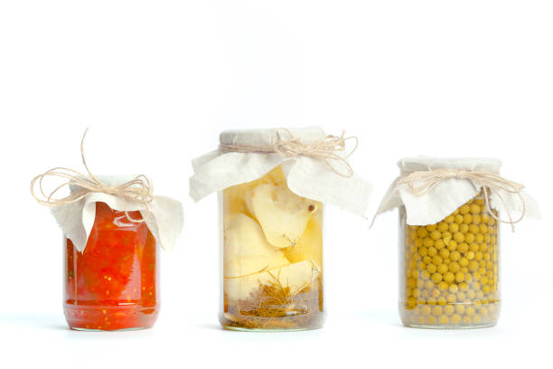 istock Canned vegetables in glass jars isolated on white background 1154037280
