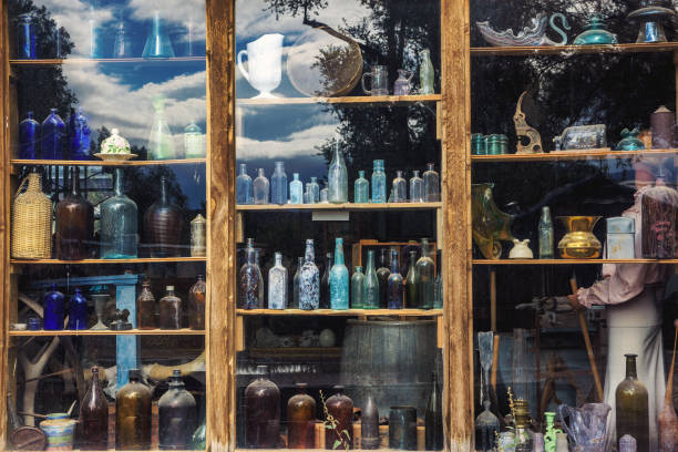 Multi-colored bottles in the window.Electric lighting creates a beautiful look.