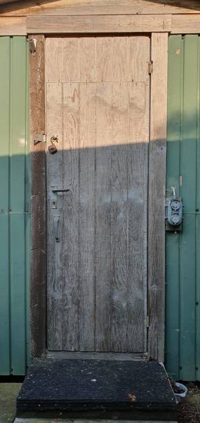 istock Old wooden door with Rusty padlock 1154038590