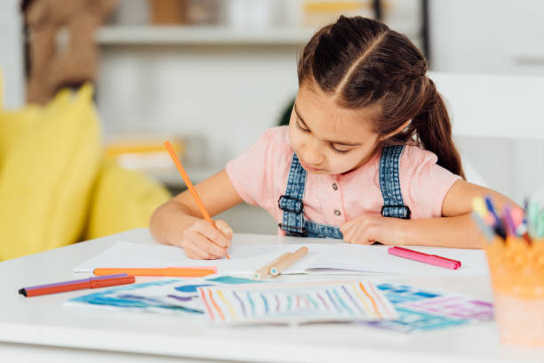 istock selective focus of cute kid drawing on paper at home 1154038675
