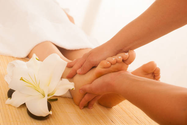 istock Close-up of female hands doing foot massage 1154041282