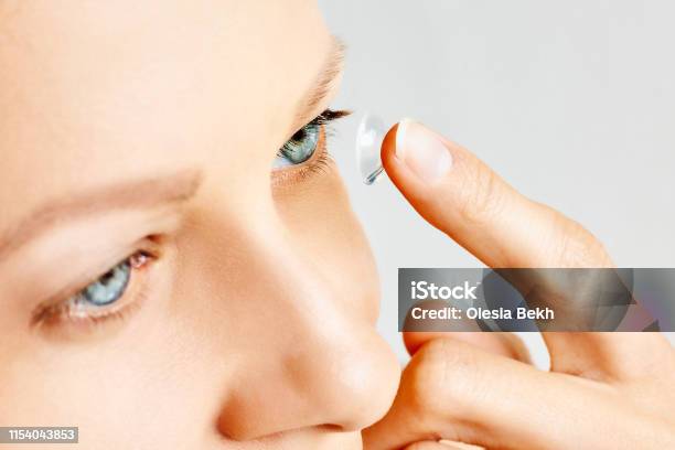 Young Woman Puts Contact Lens In Her Eye Stock Photo - Download Image Now - Adult, Adults Only, Applying