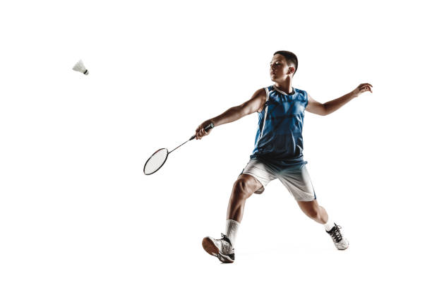 istock Little boy playing badminton isolated on white studio background 1154045234