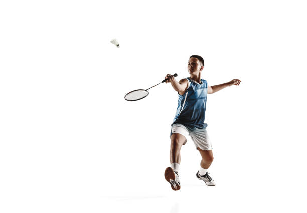 istock Little boy playing badminton isolated on white studio background 1154045243