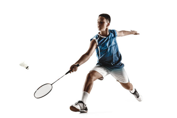 istock Little boy playing badminton isolated on white studio background 1154045252