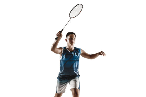istock Little boy playing badminton isolated on white studio background 1154045265