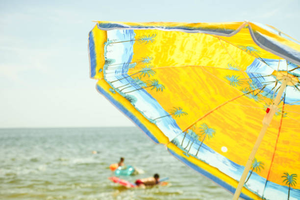 istock orange sun umbrella on beach 1154048996