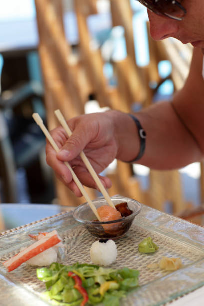 istock Man eating nigiri zushi 1154049161