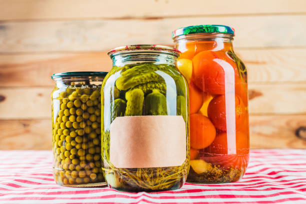 istock Preserved vegetables on wooden background 1154050488